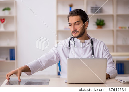 Young male doctor radiologist working in the clinic Young male doctor radiologist working in the clinic 87659584