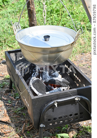Stew in a silver pot at the campsite 87659798