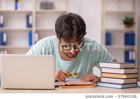 Young male student preparing for exams in the classroom 87660186