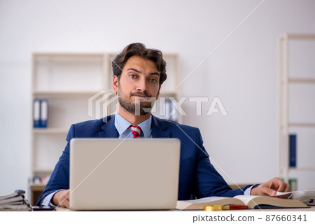 Young male employee working in the office Young male employee working in the office 87660341