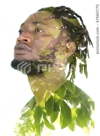 A portrait of a man dissolving into an image of foliage. Double exposure. A portrait of a man dissolving into an image of foliage. Double exposure. 87660770