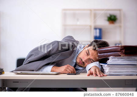 Young male employee in oversleeping concept Young male employee in oversleeping concept 87660848