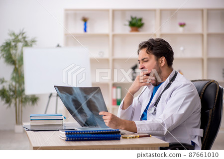 Young male doctor radiologist working in the clinic 87661010