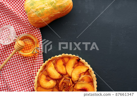 Top view of apple pie on wooden board 87661347