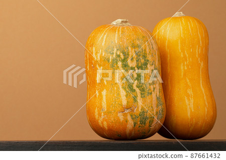Orange pumpkin on beige background front view Orange pumpkin on beige background front view 87661432