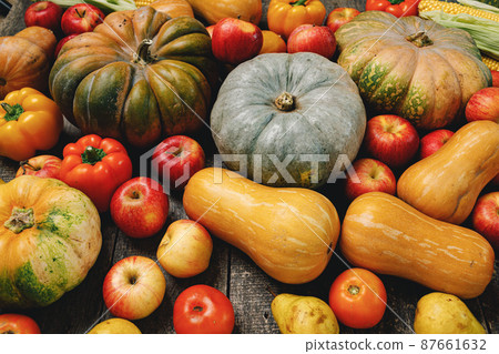 Pumpkins and red apples on wooden background 87661632