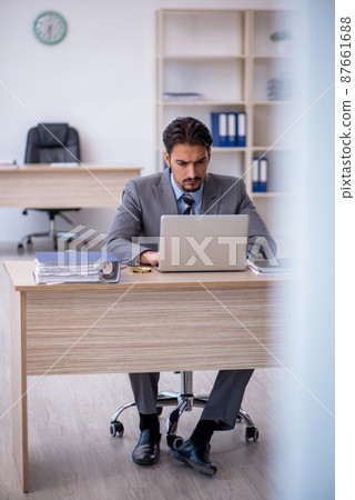 Young male employee working in the office 87661688