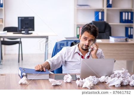 Young male employee in brainstorming concept 87661782