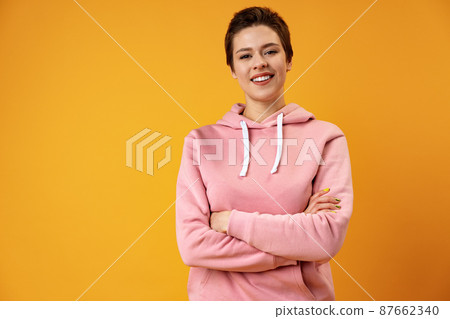 Studio portrait of young smiling woman with short hair. 87662340