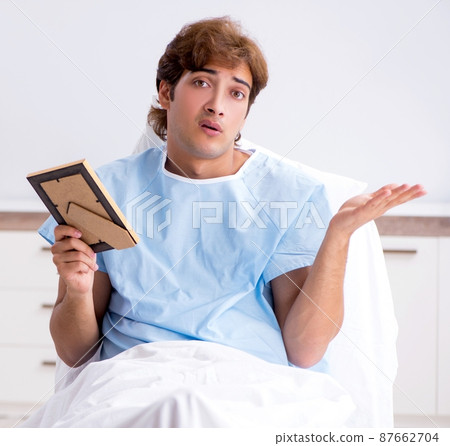 Young male patient lying on couch in hospital Young male patient lying on couch in hospital 87662704