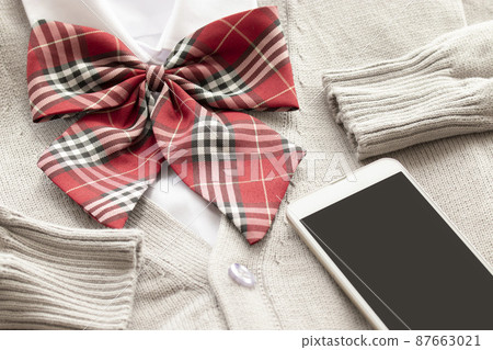 A smartphone on a school uniform blazer A smartphone on a school uniform blazer 87663021