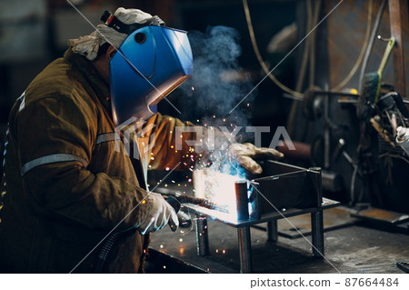 Welder welding metal steel industrial part construction on factory. Welder welding metal steel industrial part construction on factory. 87664484
