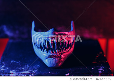 Scary plastic mask. Artisan craftsman create mask based on plaster cast. Gypsum mold and plastic mask sculpting. Scary plastic mask. Artisan craftsman create mask based on plaster cast. Gypsum mold and plastic mask sculpting. 87664489