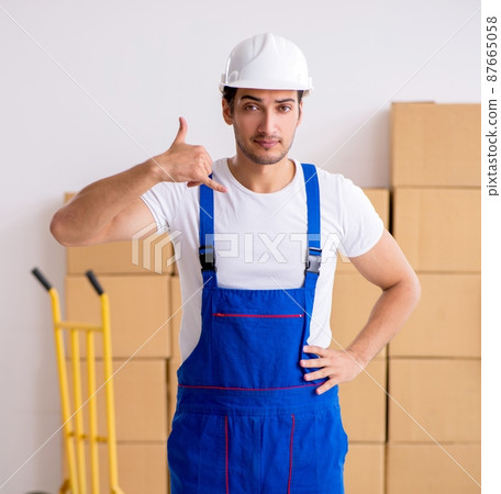Young male professional mover doing home relocation Young male professional mover doing home relocation 87665058