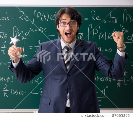 Young male math teacher in classroom Young male math teacher in classroom 87665295
