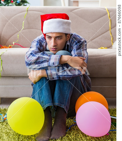 Man having hangover after christmas party Man having hangover after christmas party 87666098