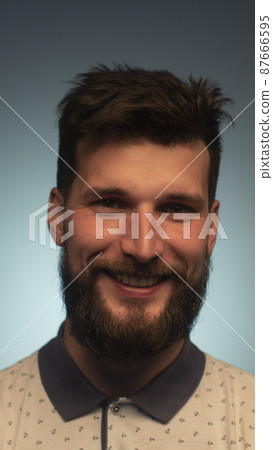 Young handsome man with beard wearing casual polo with anchors over blue background. Smiling relaxed and cheerful. Success and optimistic Young handsome man with beard wearing casual polo with anchors over blue background. Smiling relaxed and cheerful. Success and optimistic 87666595