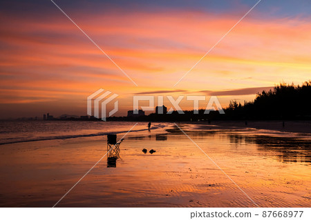 Silhouette chair and sandals on beach at dusk, Cha Am beach 87668977
