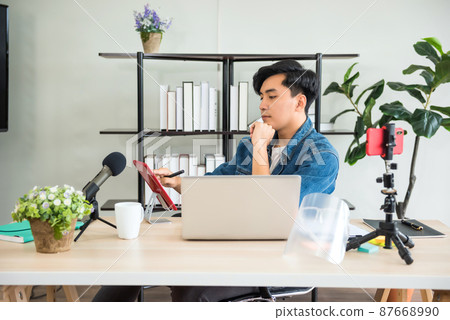 Young Asian blogger recording live streaming video on his blog 87668990