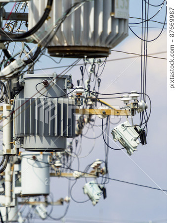 Scenery where utility poles and pole transformers are crowded 87669987