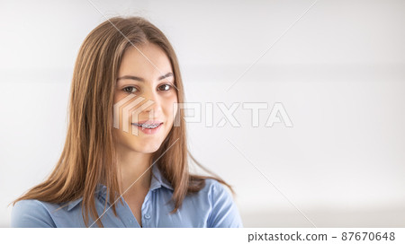 Portrait of happy smiling girl with dental braces 87670648