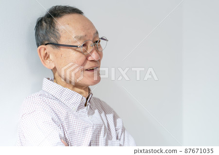 Senior male thinking arms folded Senior male thinking arms folded 87671035