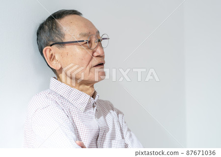 Senior male thinking arms folded Senior male thinking arms folded 87671036