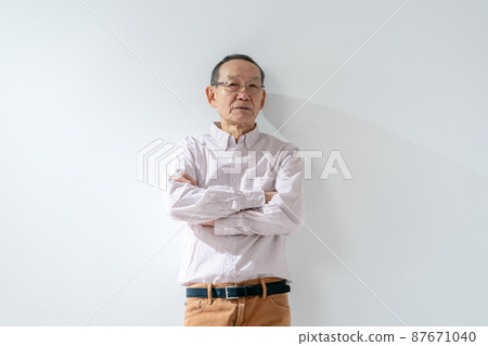 Senior male thinking arms folded 87671040