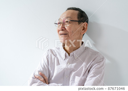 Senior male thinking arms folded 87671046