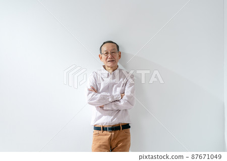 Senior male thinking arms folded 87671049