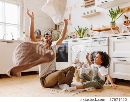 Excited father and kid playing with towels 87671430