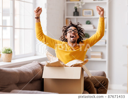 African American man cheering about delivered parcel African American man cheering about delivered parcel 87671433