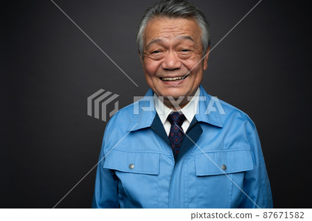 A man in work clothes smiling A man in work clothes smiling 87671582