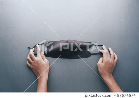 holding a black color cloth face masks top view holding a black color cloth face masks top view 87674674