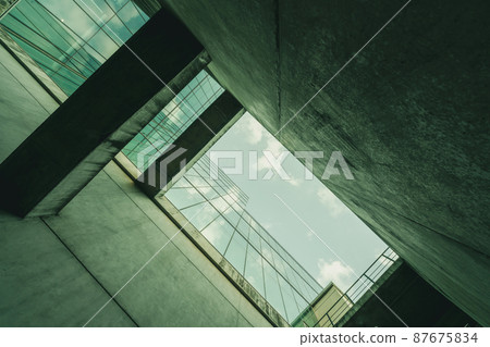 Bottom view modern glass office building. Exterior office glass building architecture. Company glass window. Skyscraper corporate building. Financial business center tower. Perspective of building. 87675834