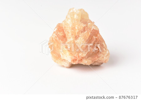 One  uncut and rough Sunstone crystal,quartz on white 87676317
