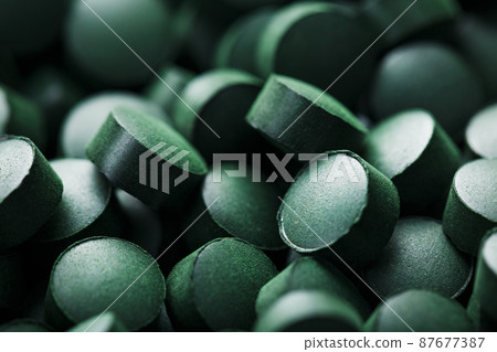 Close-up of Green tablets of organic spirulina 87677387