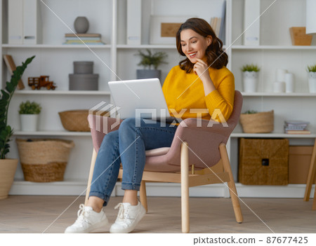 woman using laptop woman using laptop 87677425