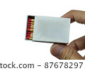 someone hold the red matchbox opened isolated on white background. Side view and Blank space 87678297
