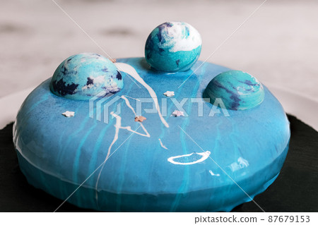 Blue mousse cake with blue chocolate balls Blue mousse cake with blue chocolate balls 87679153