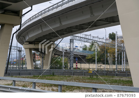 Car overpass over the railroad tracks in the city. Car overpass over the railroad tracks in the city. 87679393