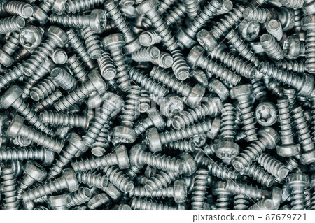 A huge arrenge of taping metal or iron screws, screws as a background, wallpaper or texture, industrial background and concept 87679721