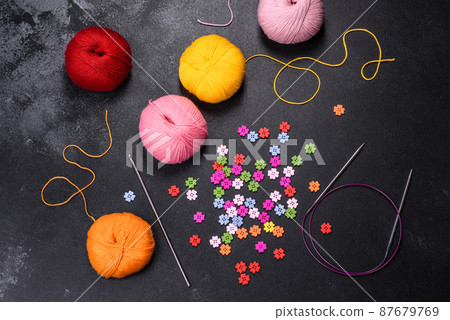 Colorful balls of wool on concrete table. Variety of yarn balls Colorful balls of wool on concrete table. Variety of yarn balls 87679769