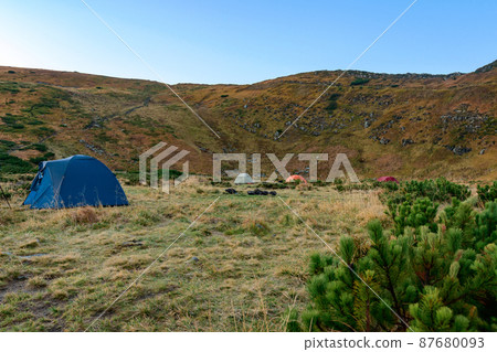 Tent camp near Lake Nesamovyto, morning in a camp town in the mountains. Tent camp near Lake Nesamovyto, morning in a camp town in the mountains. 87680093