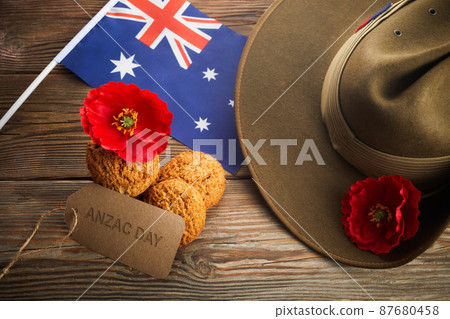 Australian Anzac Day. Australian army slouch hat and traditional Anzac biscuits on wooden background. Australian Anzac Day. Australian army slouch hat and traditional Anzac biscuits on wooden background. 87680458