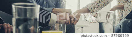 Business colleagues bumping fists together 87680569