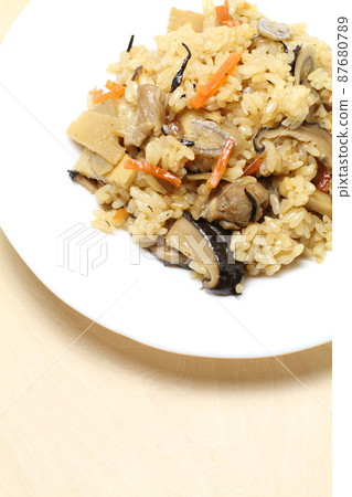 Chicken Gome cooked rice, Gome rice served on a white plate, Shiraki wood grain back Chicken Gome cooked rice, Gome rice served on a white plate, Shiraki wood grain back 87680789