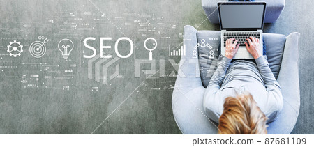 SEO concept with man using a laptop SEO concept with man using a laptop 87681109
