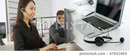Business people wearing headset working in office broaden view Business people wearing headset working in office broaden view 87681669