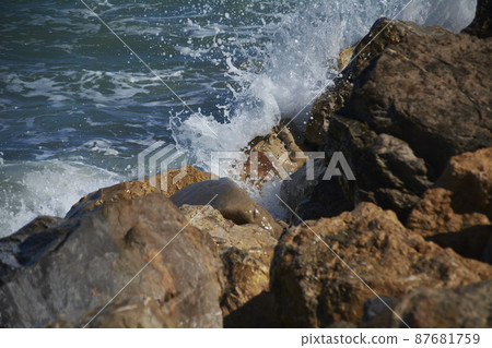 The sea splashing rocks on the shore The sea splashing rocks on the shore 87681759